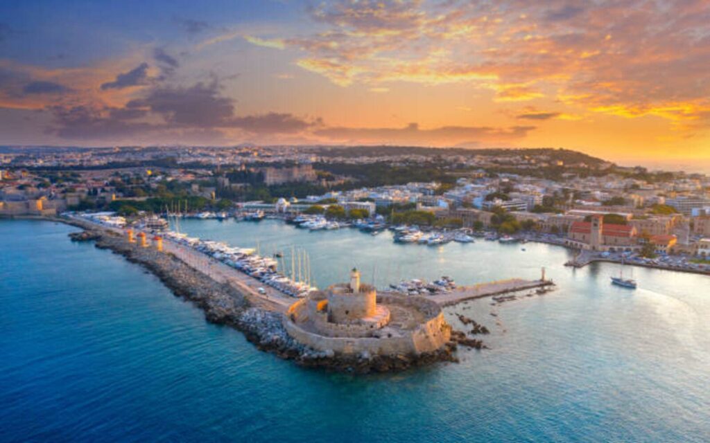 Rhodes harbor and city view at sunset popular destination for airport transfers in Rhodes Greece
